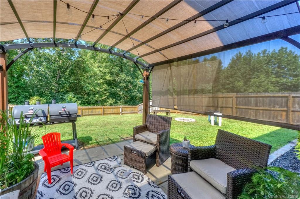 7550 West Berkeley Road, Unit 22 Denver, NC 28037 - Photo 17 of 20 a backyard of a house with outdoor seating