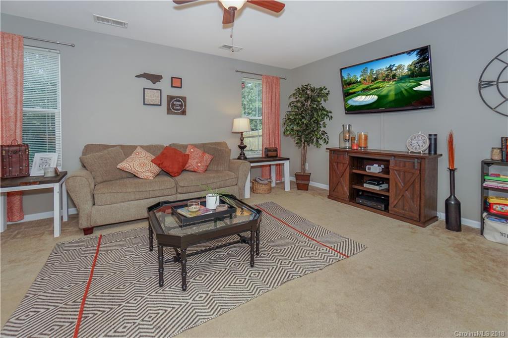 7550 West Berkeley Road, Unit 22 Denver, NC 28037 - Photo 3 of 20 a living room with furniture and a flat screen tv