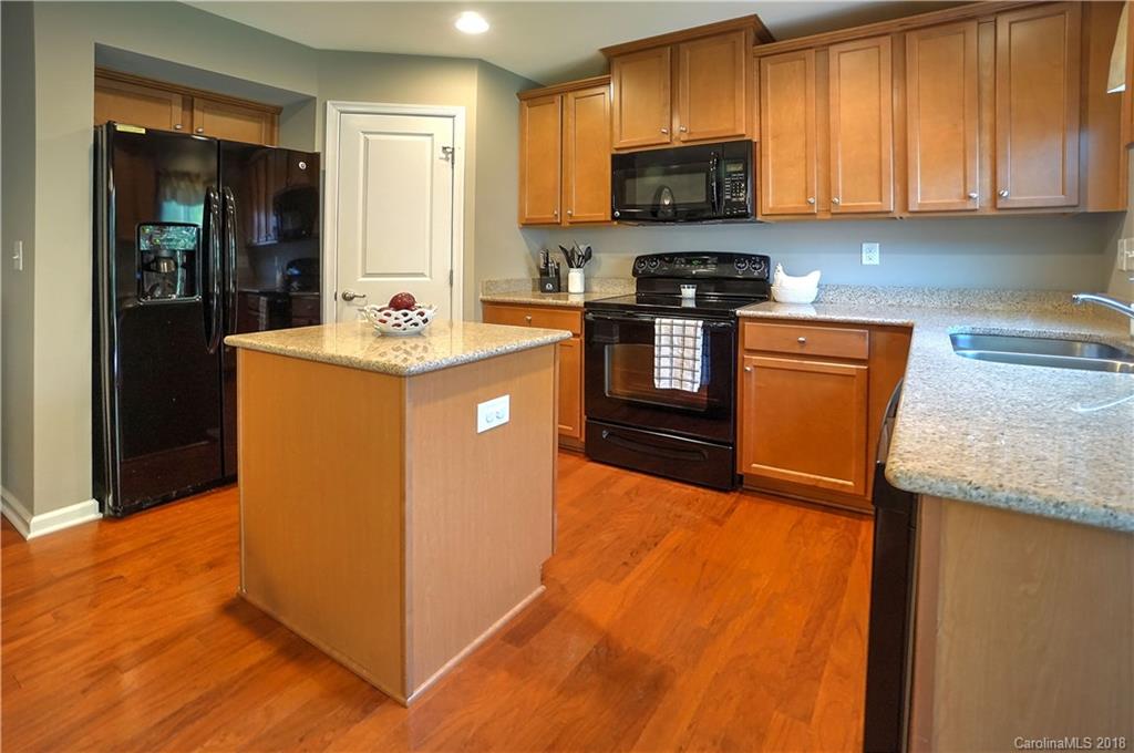 7550 West Berkeley Road, Unit 22 Denver, NC 28037 - Photo 4 of 20 a kitchen with granite countertop a sink a stove and refrigerator