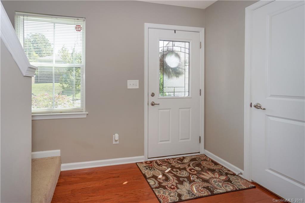 7550 West Berkeley Road, Unit 22 Denver, NC 28037 - Photo 6 of 20 a view of an empty room with a window and wooden floor