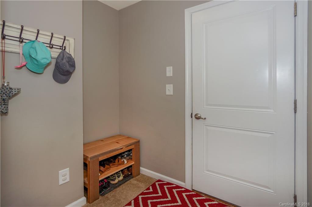 7550 West Berkeley Road, Unit 22 Denver, NC 28037 - Photo 8 of 20 a room with a bed and potted plant