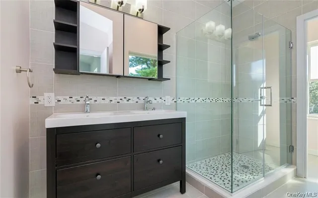 a bathroom with a sink a vanity and a window
