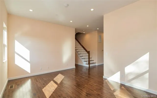 a kitchen with stainless steel appliances a refrigerator and wooden floor
