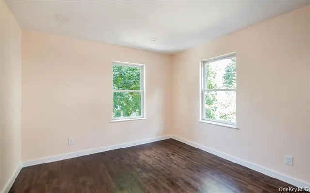 a view of a kitchen with stainless steel appliances granite countertop a large counter top and a wooden floor