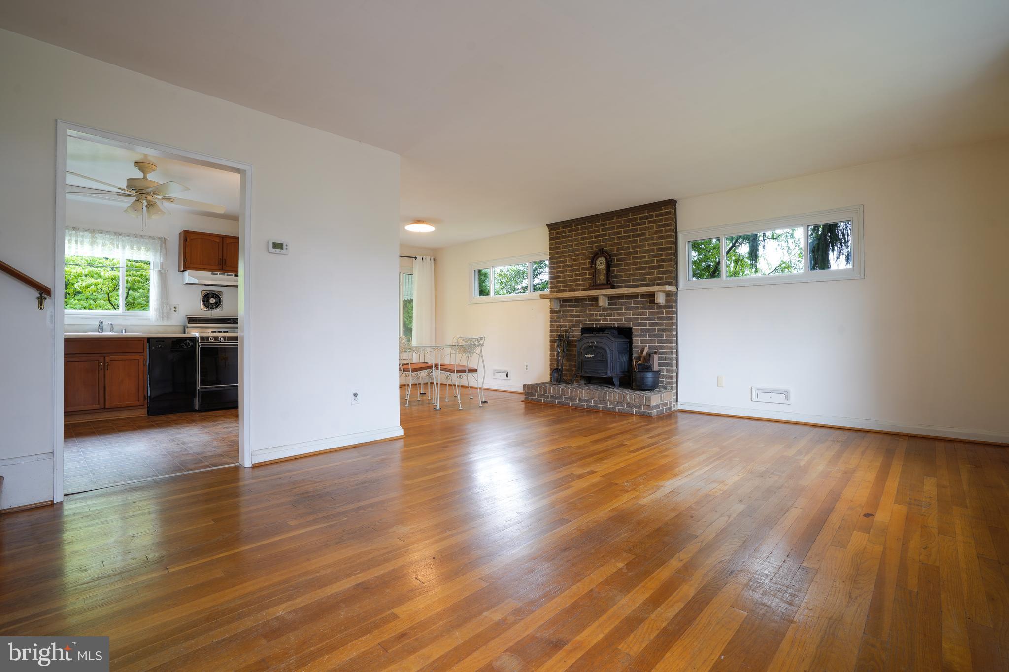 1073 Southridge Road Baltimore, MD 21228 - Photo 3 of 27 a view of a livingroom with furniture a fireplace and wooden floor
