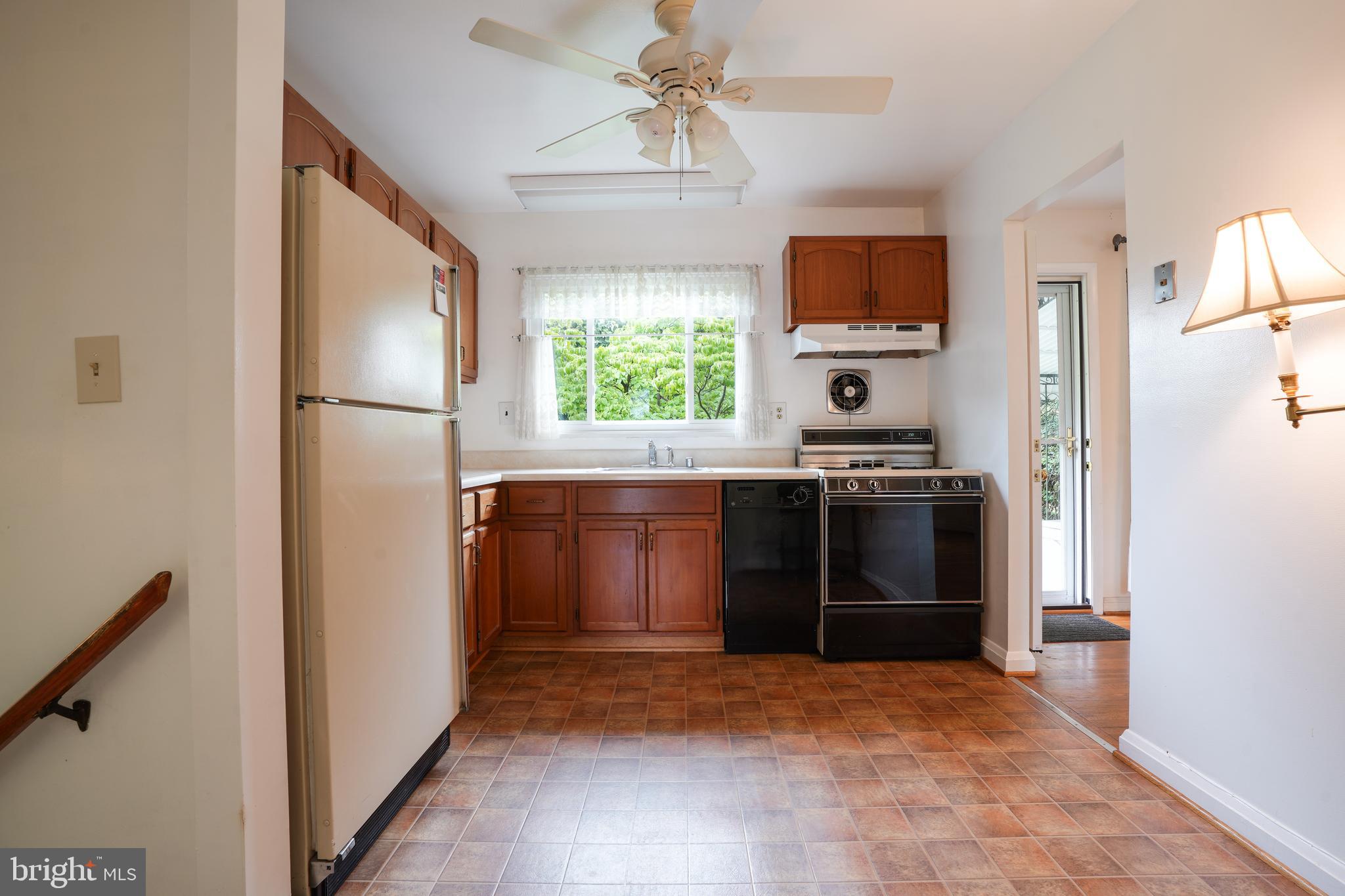 1073 Southridge Road Baltimore, MD 21228 - Photo 8 of 27 a kitchen with a refrigerator and a sink