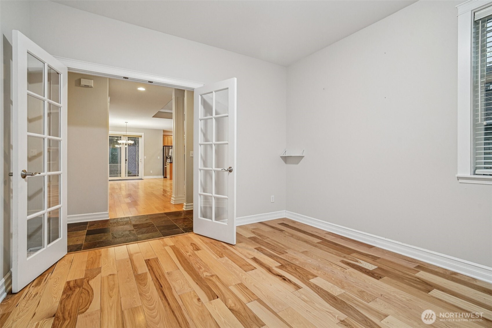 2617 Fir Crest Boulevard Anacortes, WA 98221 - Photo 11 of 31 a bedroom with a bed and wooden floor