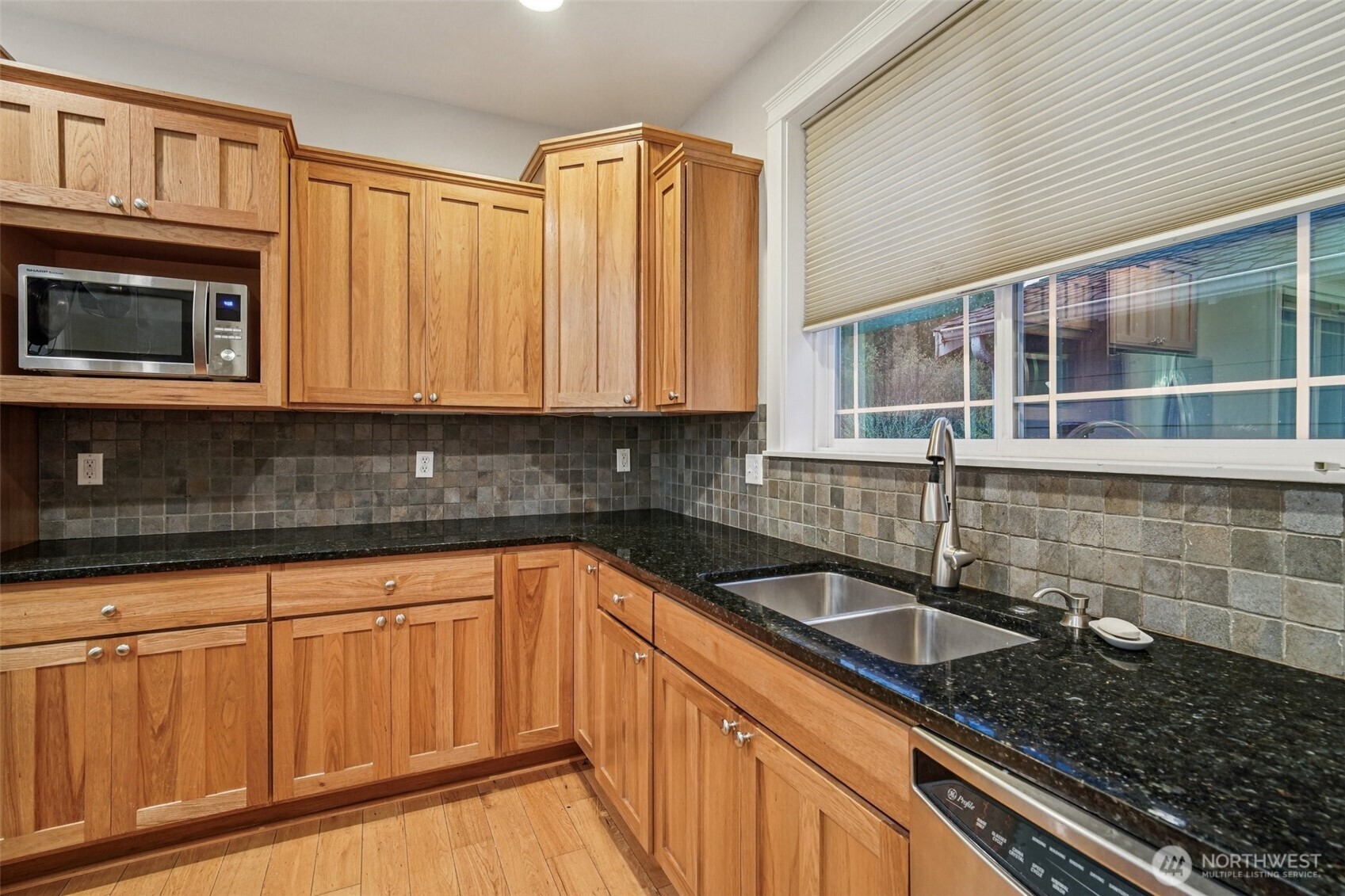 2617 Fir Crest Boulevard Anacortes, WA 98221 - Photo 8 of 31 a kitchen with granite countertop a sink a stove and cabinets