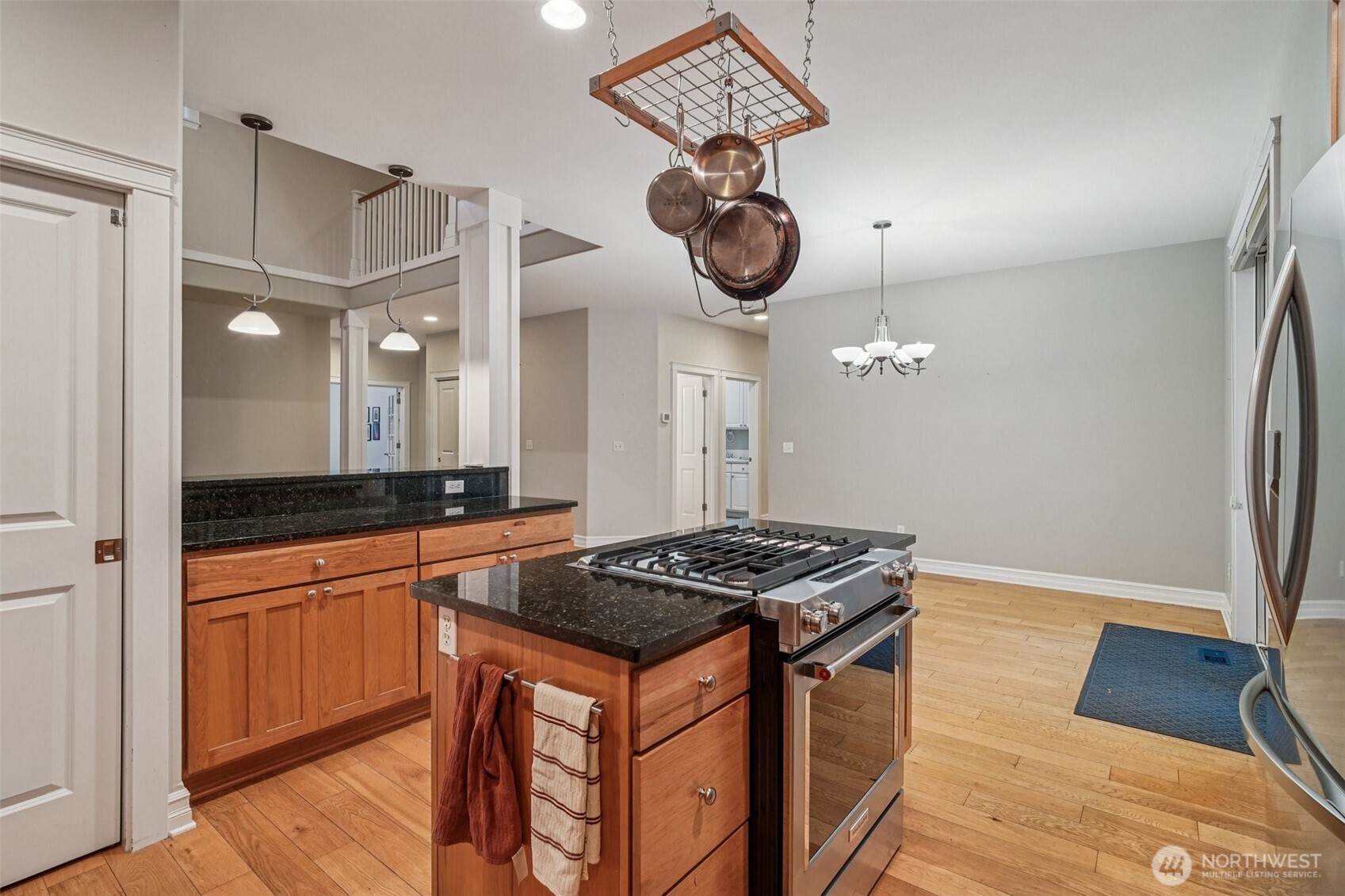 2617 Fir Crest Boulevard Anacortes, WA 98221 - Photo 9 of 31 a kitchen with stainless steel appliances granite countertop a stove a sink and a refrigerator with wooden floor