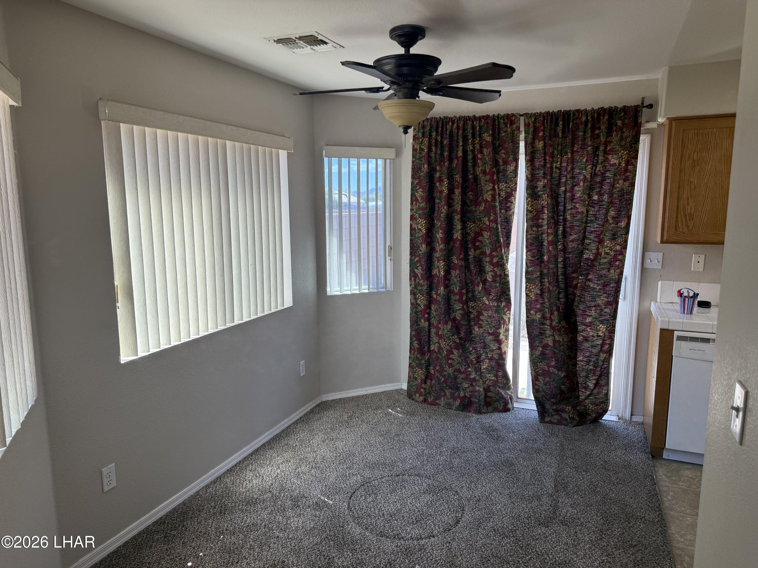 4897 South Rinaldi Drive Fort Mohave, AZ 86426 - Photo 5 of 22 wooden floor in an empty room with a window