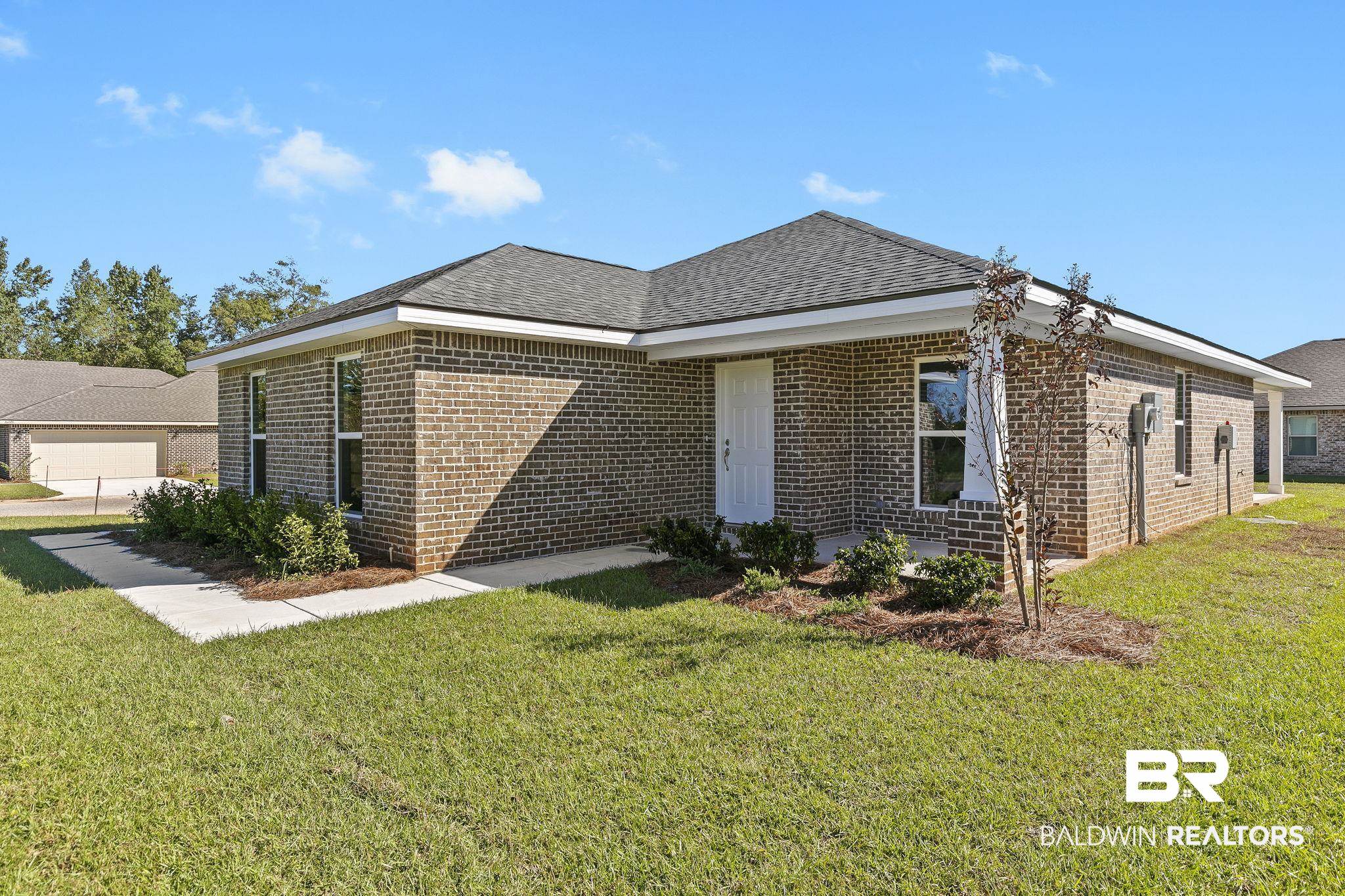 16014 Alabama Avenue Silverhill, AL 36576 - Photo 5 of 50 View of front facade featuring a garage and a front lawn