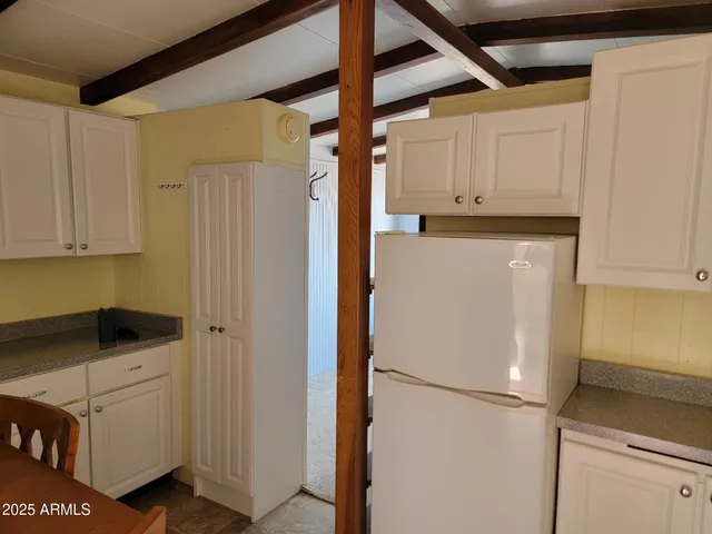 a white refrigerator freezer sitting in a kitchen