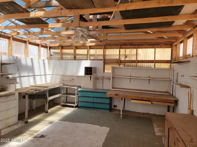 a room with lots of wooden furniture and a window