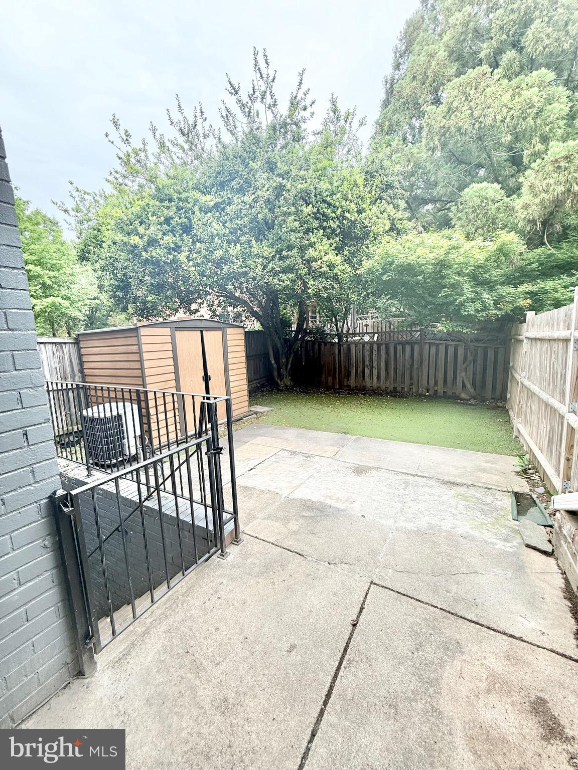 5439 Richenbacher Avenue Alexandria, VA 22304 - Photo 23 of 23 a view of a backyard with a large tree and wooden fence