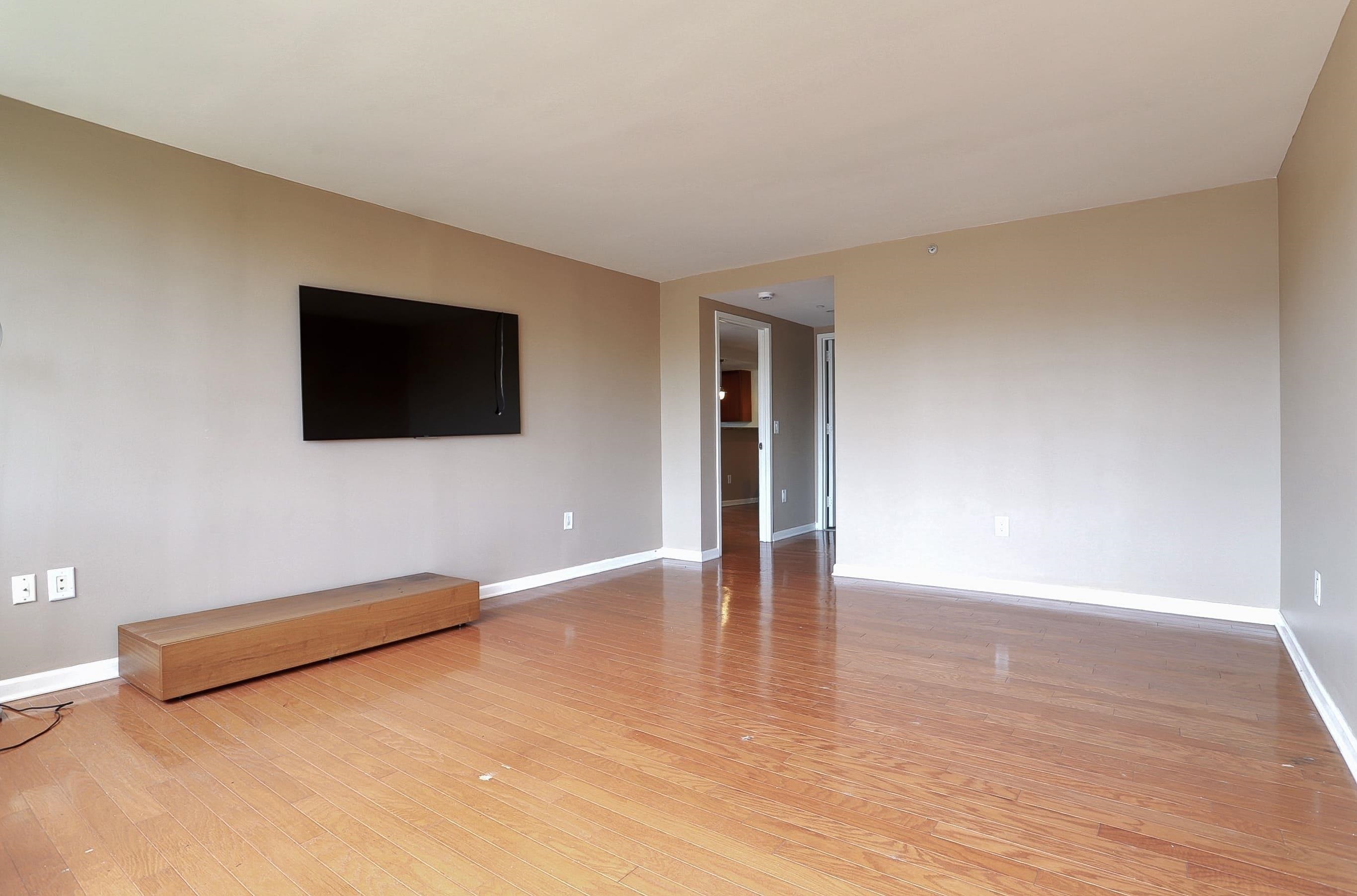 700 Grove Street, Unit 4F Jersey City, NJ 07310 - Photo 18 of 30 a view of an empty room with wooden floor and a window