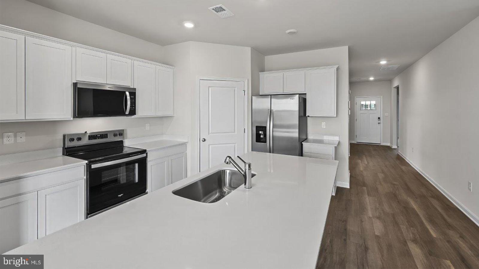42 Riderwood Way Shepherdstown, WV 25443 - Photo 11 of 28 a kitchen with stainless steel appliances a stove a sink a microwave and cabinets
