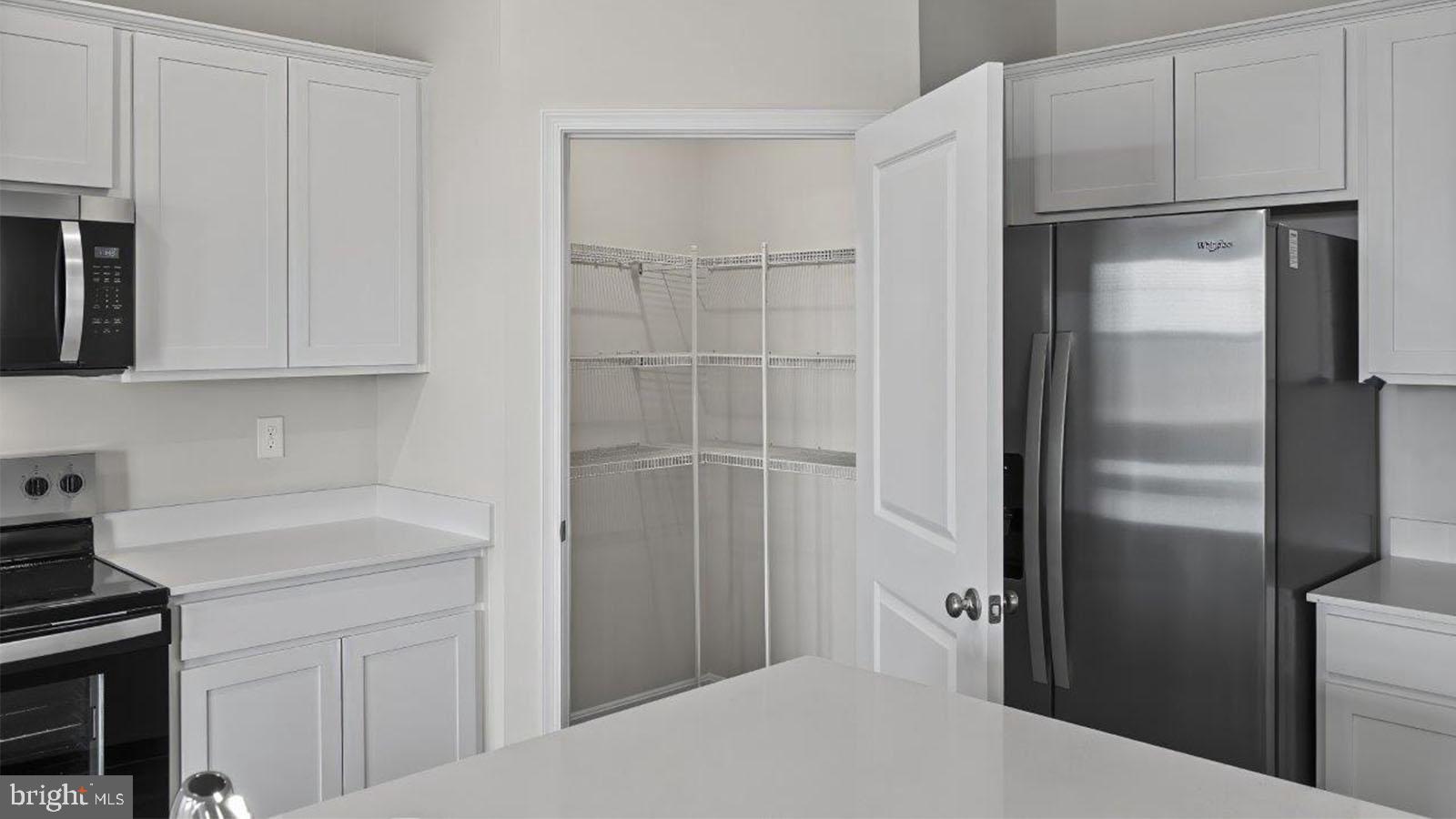 42 Riderwood Way Shepherdstown, WV 25443 - Photo 9 of 28 a kitchen with a refrigerator and cabinets