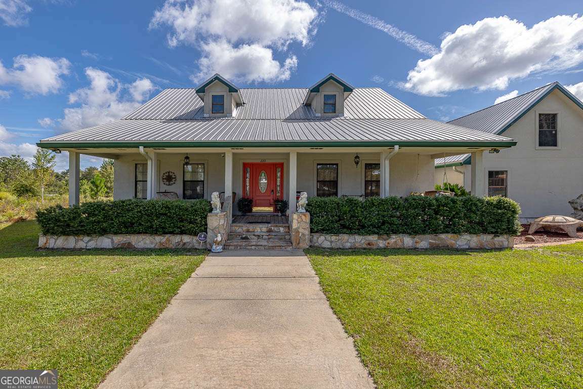a front view of a house with yard and green space