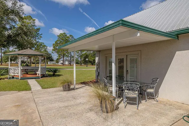 a view of a house with backyard porch and sitting area
