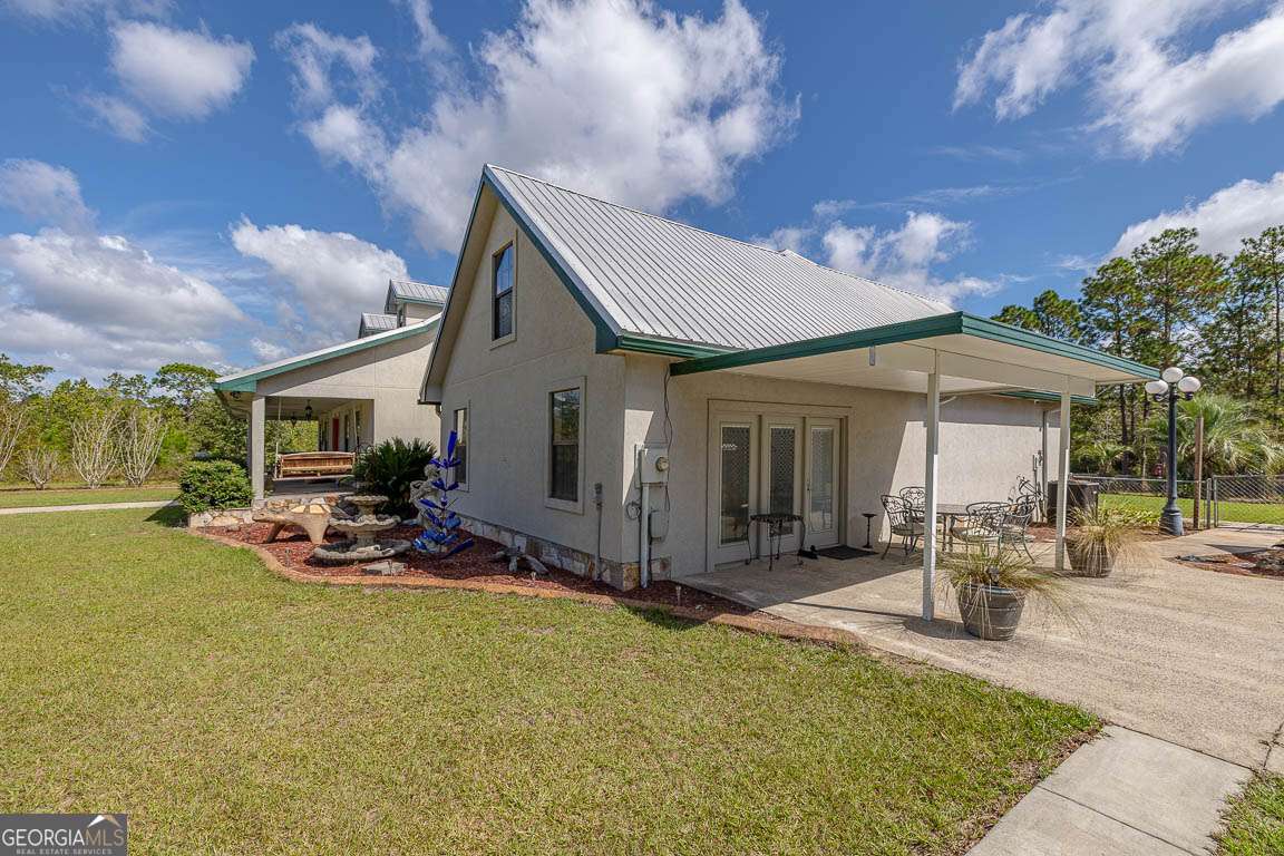 220 Chickasaw Road Hoboken, GA 31542 - Photo 14 of 55 a front view of a house with sitting area and garden