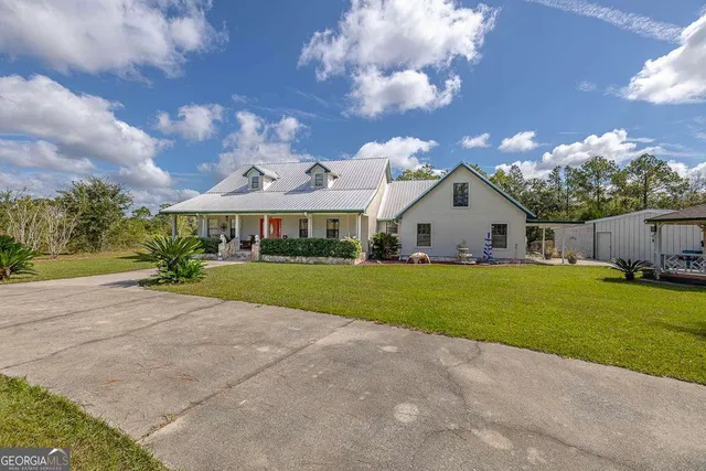 a front view of house with yard and green space
