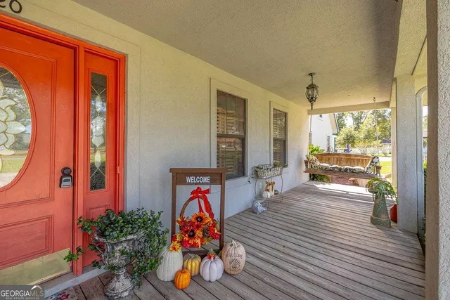 a view of a room with wooden floor and windows