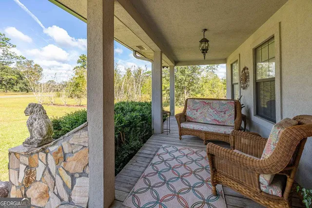 a view of a dining room with furniture and floor to ceiling windows