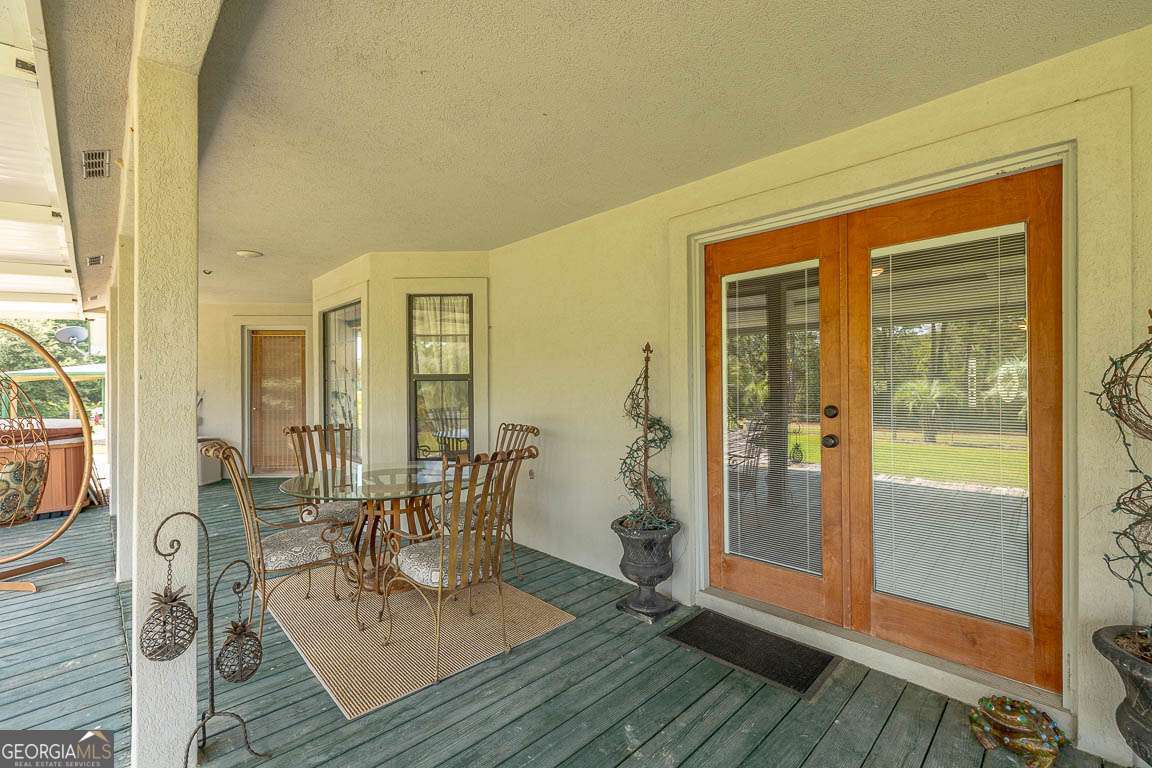 220 Chickasaw Road Hoboken, GA 31542 - Photo 19 of 55 a view of a dining room with furniture and floor to ceiling windows