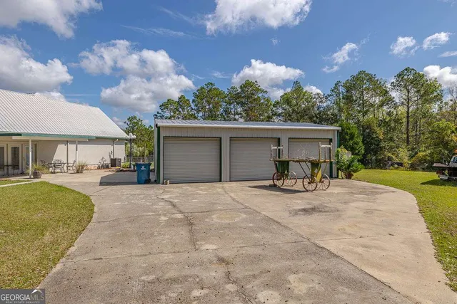 a view of a house with backyard and sitting area