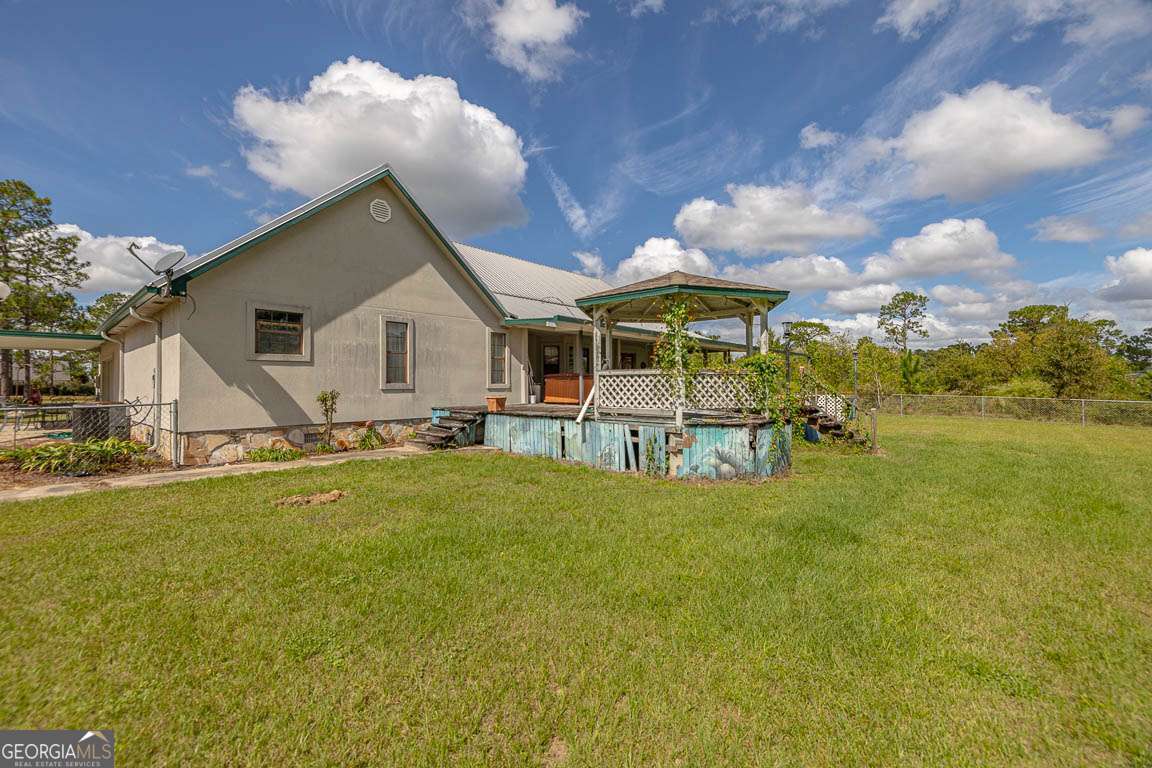 220 Chickasaw Road Hoboken, GA 31542 - Photo 26 of 55 a view of a house with pool and chairs
