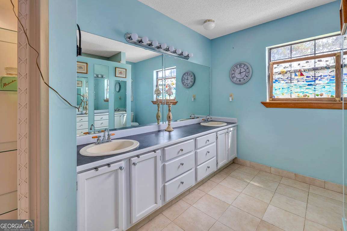 220 Chickasaw Road Hoboken, GA 31542 - Photo 29 of 55 a spacious bathroom with a double vanity sink and a mirror