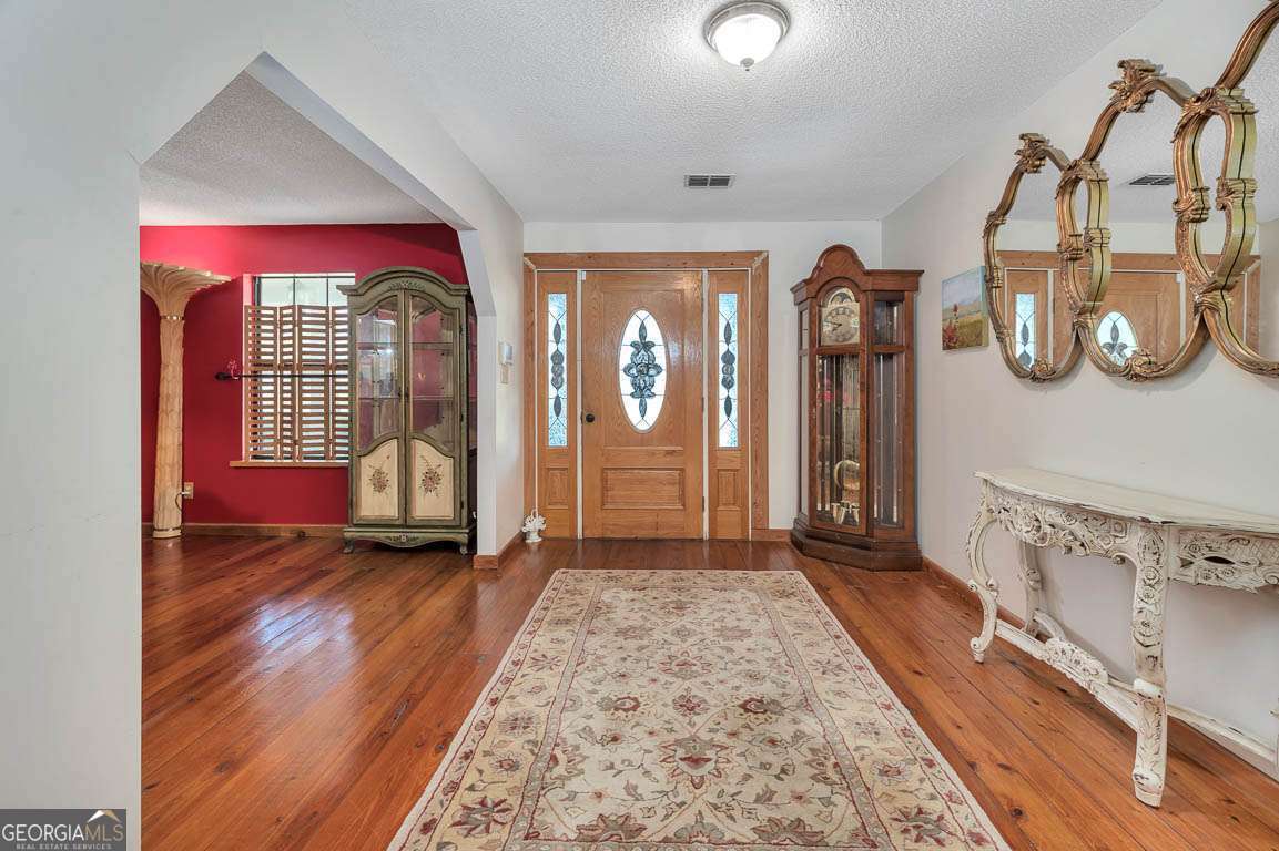 220 Chickasaw Road Hoboken, GA 31542 - Photo 31 of 55 a view of a hallway with wooden floor and windows