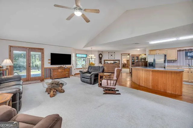 a dining room with wooden floor a chandelier a wooden table and chairs