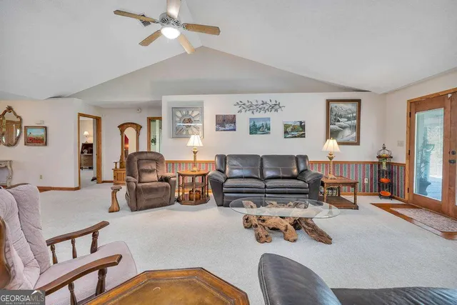 a view of living room with furniture and a chandelier