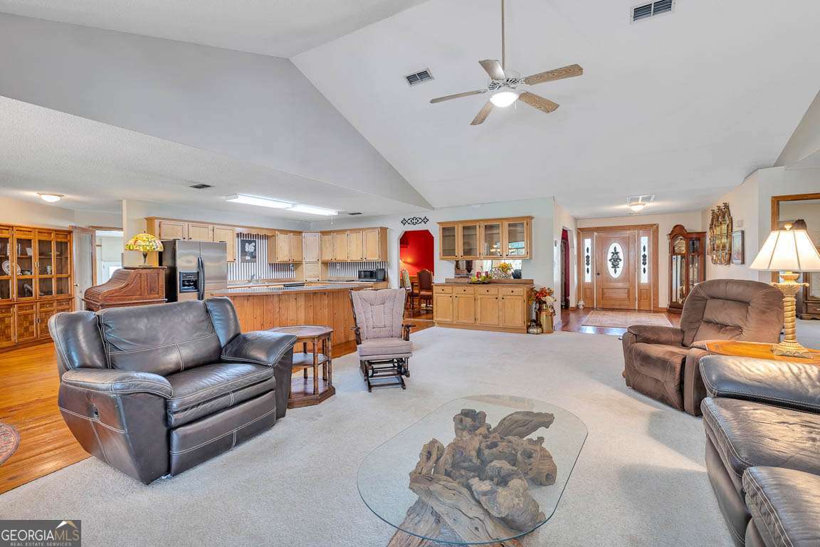 220 Chickasaw Road Hoboken, GA 31542 - Photo 40 of 55 a living room with furniture kitchen view and a wooden floor
