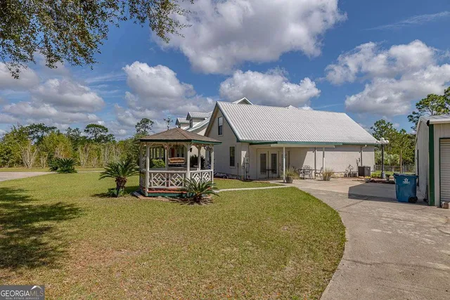 a front view of a house with garden