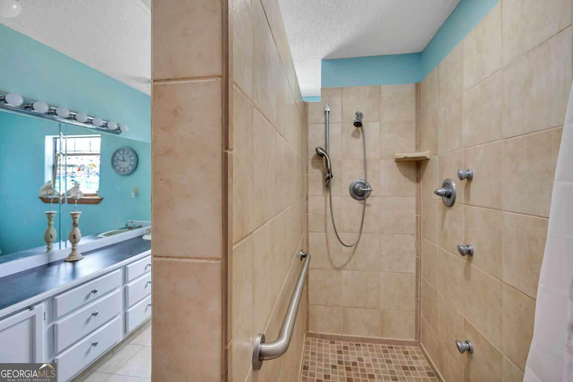 220 Chickasaw Road Hoboken, GA 31542 - Photo 50 of 55 a bathroom with a shower sink and mirror