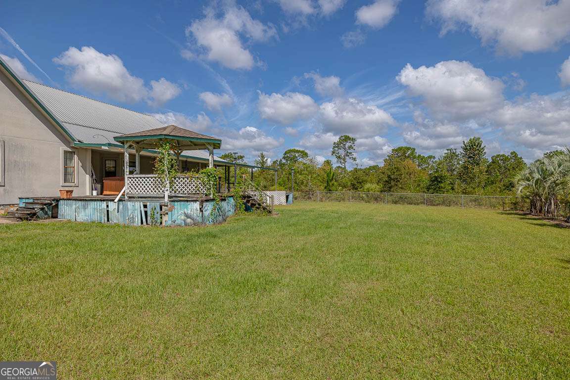 220 Chickasaw Road Hoboken, GA 31542 - Photo 10 of 55 a view of a big yard with a house in the background