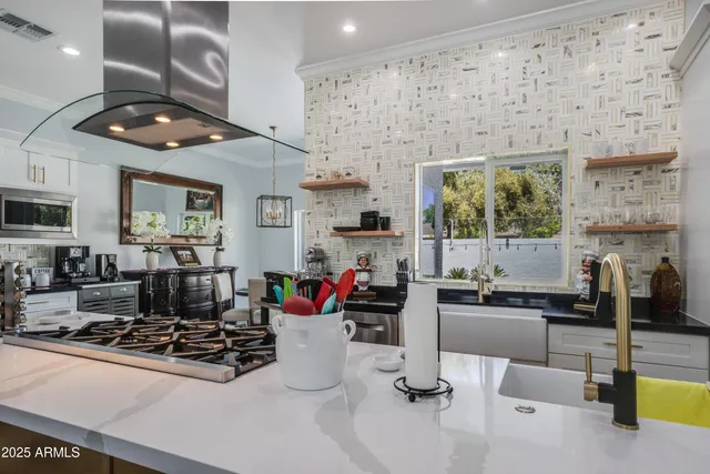 a living room with fireplace furniture and a large window