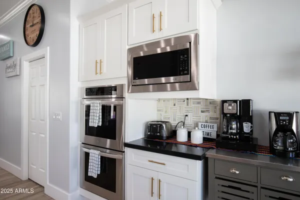 a kitchen with stainless steel appliances granite countertop a stove a microwave a sink and cabinets