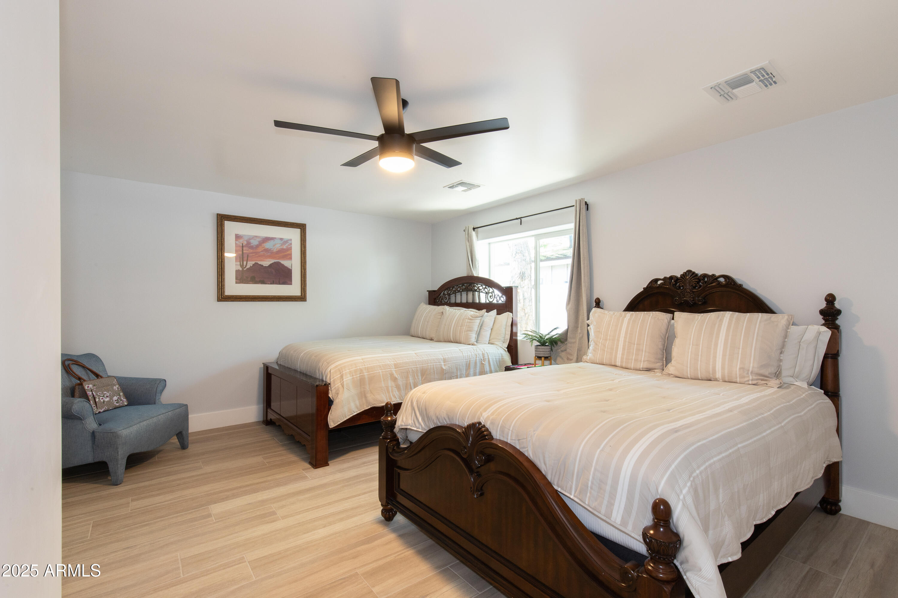 516 West Rancho Drive Phoenix, AZ 85013 - Photo 20 of 46 a bedroom with two beds and a chandelier
