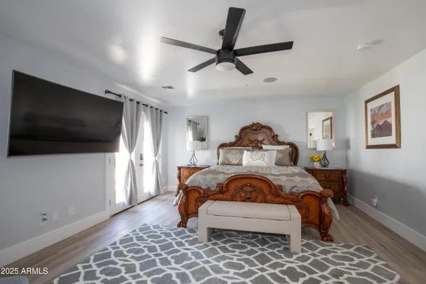 a bedroom with a bed and a flat screen tv