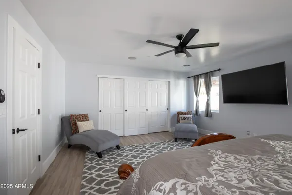 a bedroom with a bed and a flat screen tv