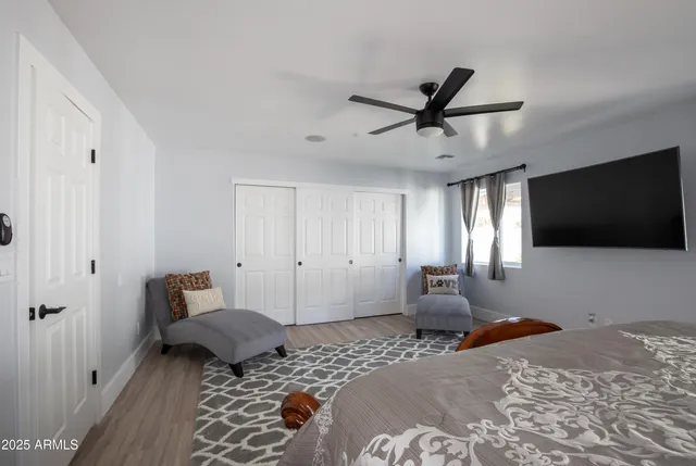 a bedroom with a bed and a flat screen tv