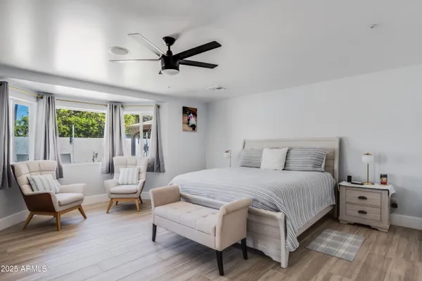 a bedroom with a bed a couch and a window