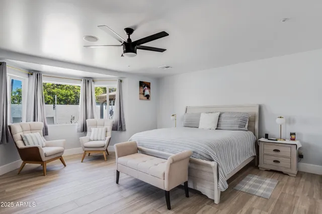 a bedroom with a bed a couch and a window