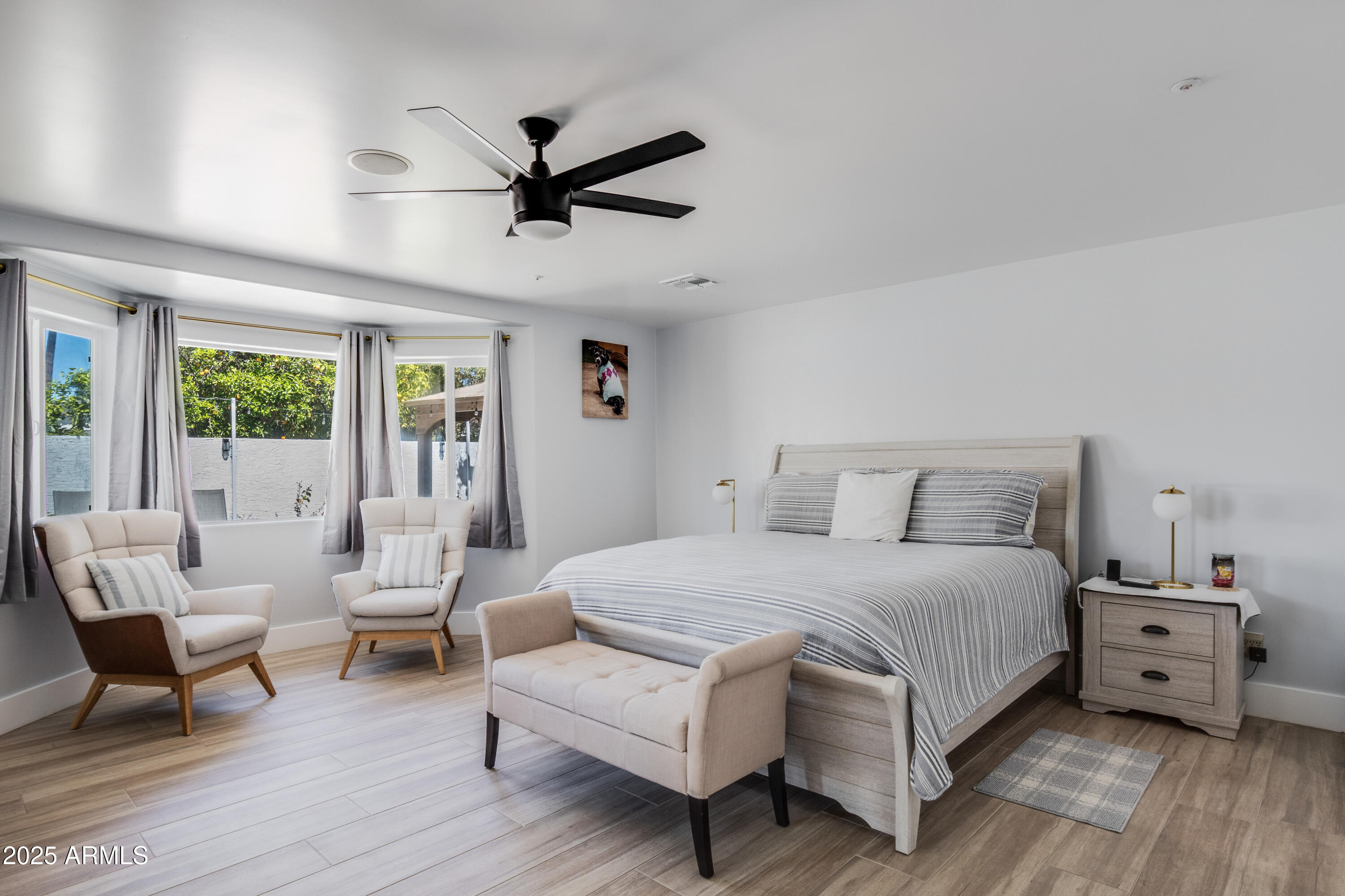 516 West Rancho Drive Phoenix, AZ 85013 - Photo 26 of 46 a bedroom with a bed a couch and a window