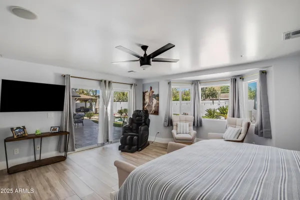 a bedroom with furniture and a flat screen tv