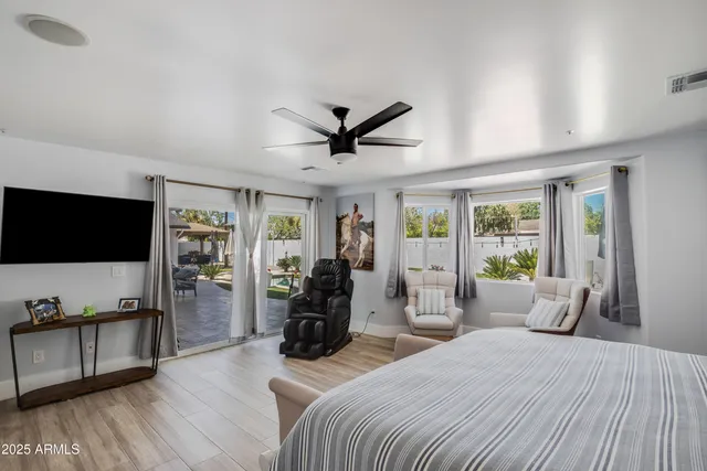 a bedroom with furniture and a flat screen tv