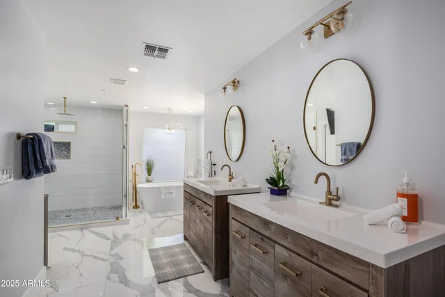 a bathroom with a double vanity sink and a mirror